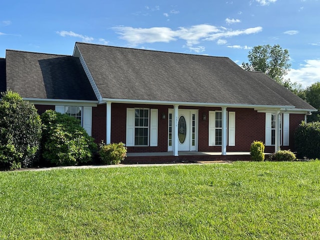 5514 Raven Xing, Baxter, TN 38544 - cape cod-style house featuring brick siding, a porch, a front lawn, and roof with shingles