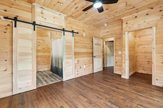 106 Raccoon Ln, Jamestown, TN 38556 - unfurnished bedroom featuring a barn door, dark wood-style flooring, wooden walls, and wood ceiling