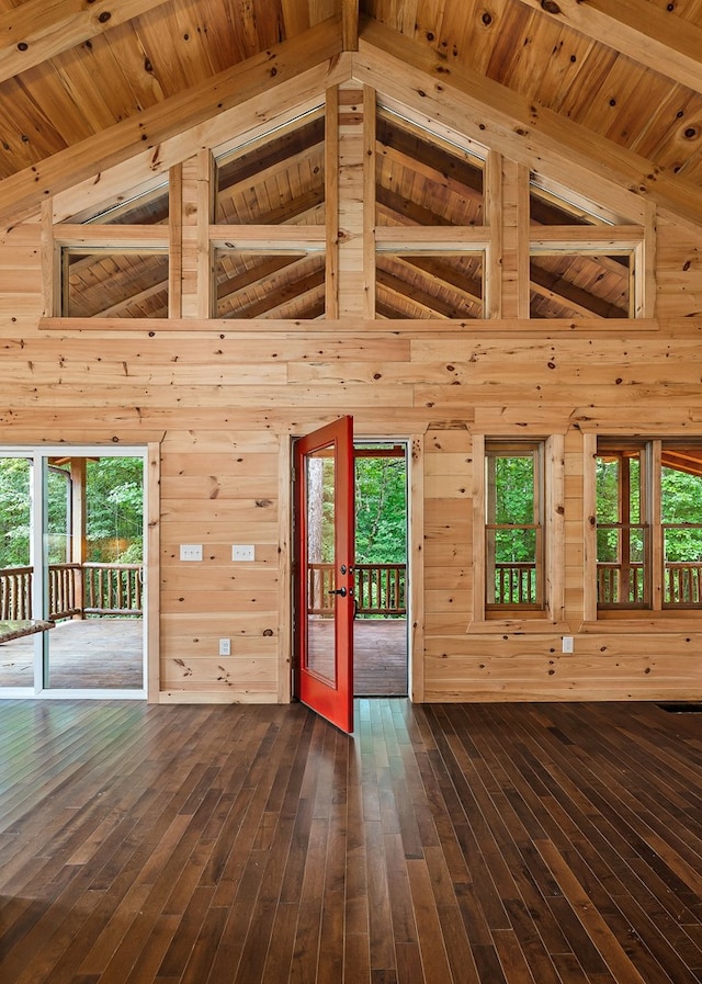 106 Raccoon Ln, Jamestown, TN 38556 - unfurnished living room with french doors, wood walls, a wooden ceiling with exposed beams, dark wood-style flooring, and high vaulted ceiling