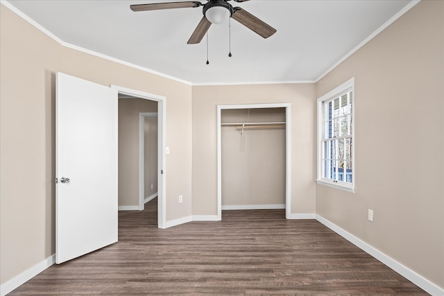 unfurnished bedroom with dark wood-style floors, baseboards, and crown molding