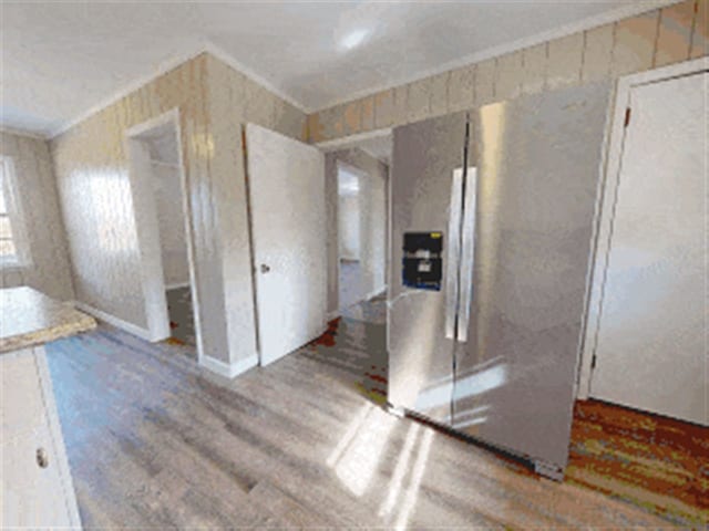 spare room featuring ornamental molding and wood finished floors