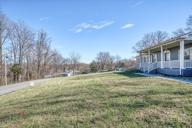 view of yard with covered porch