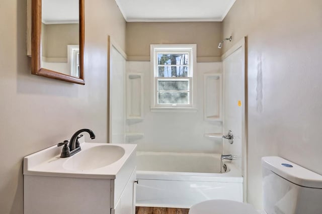 bathroom with shower / bath combination, toilet, crown molding, and vanity