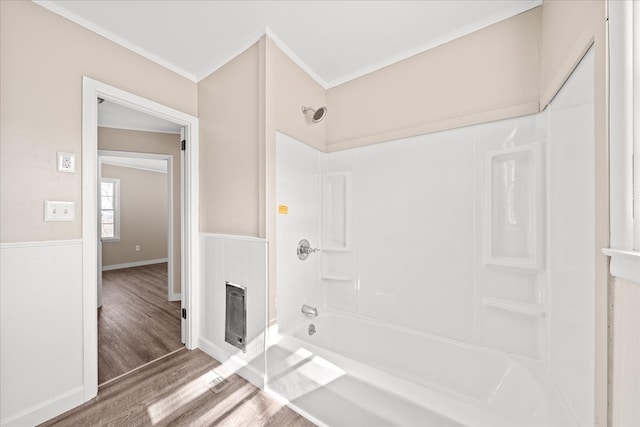 full bathroom featuring bathing tub / shower combination, wainscoting, tile walls, and wood finished floors