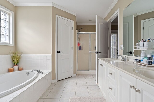 full bath with ornamental molding, a sink, a shower stall, and tile patterned floors