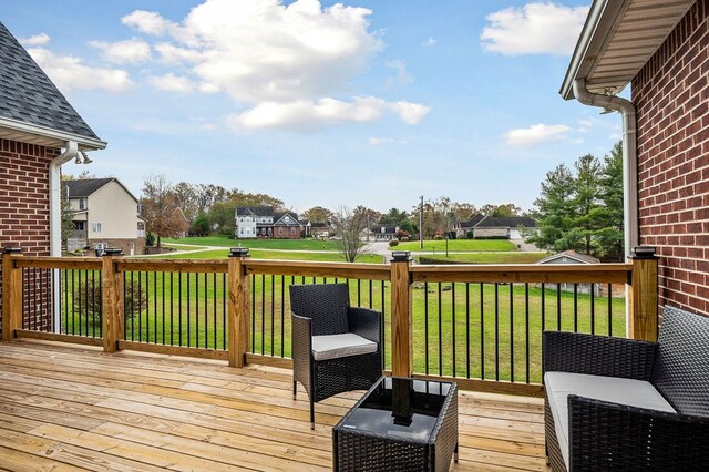 deck with a yard and a residential view