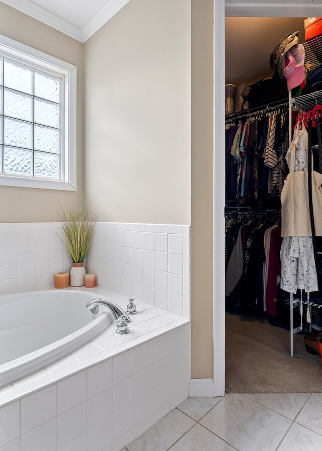 full bathroom featuring a garden tub, tile patterned flooring, a spacious closet, and ornamental molding