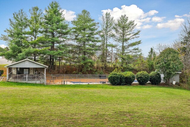 view of yard with a pool and fence