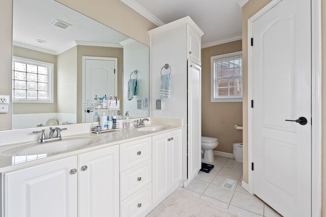 bathroom featuring ornamental molding, tile patterned flooring, a sink, and visible vents