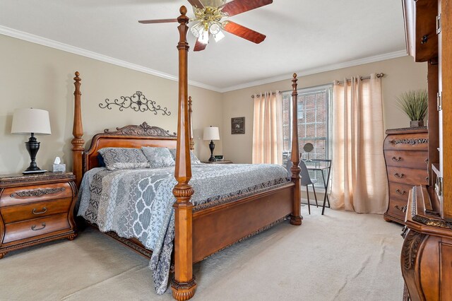 bedroom featuring ornamental molding, light colored carpet, and a ceiling fan