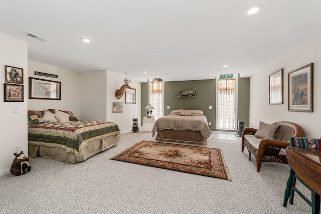 carpeted bedroom featuring baseboards, visible vents, and recessed lighting