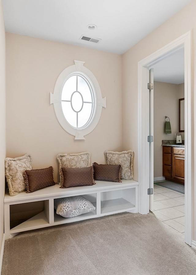 mudroom with light carpet and visible vents