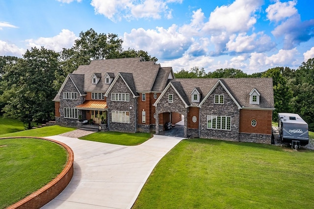 view of front of house featuring concrete driveway and a front yard