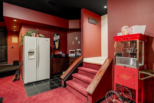 stairway with carpet floors, tile patterned flooring, visible vents, and recessed lighting