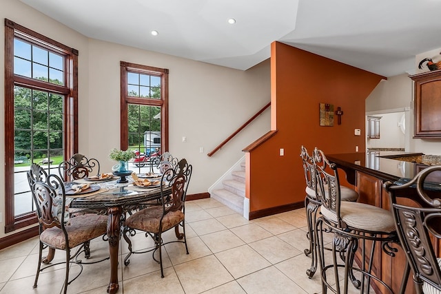 dining space with recessed lighting, light tile patterned floors, baseboards, and stairs