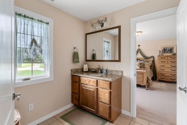 bathroom with tile patterned flooring, vanity, and baseboards