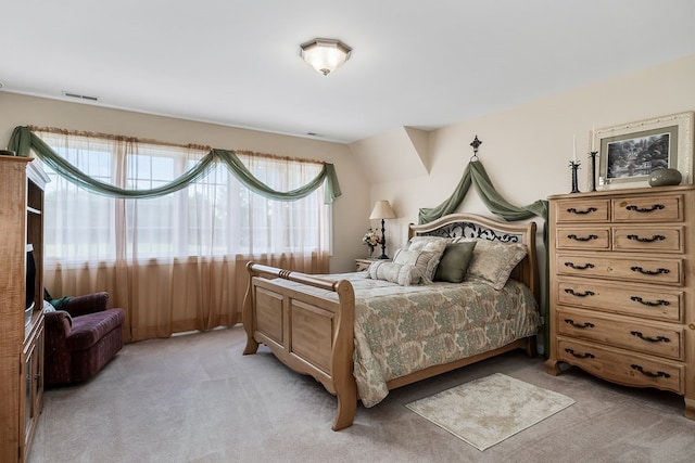 bedroom with light carpet and visible vents