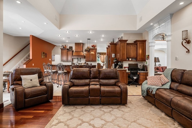 living area featuring recessed lighting, a high ceiling, visible vents, stairway, and light wood-type flooring