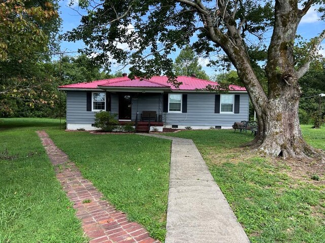 ranch-style house featuring a front yard, crawl space, covered porch, and metal roof