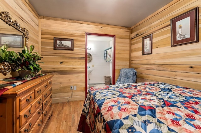 bedroom with wood finished floors and wooden walls