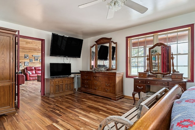 bedroom with wood finished floors and baseboards