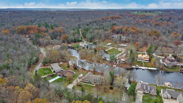 birds eye view of property with a residential view, a water view, and a view of trees