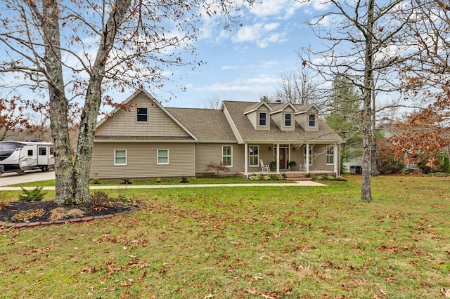 cape cod house featuring covered porch, roof with shingles, and a front yard