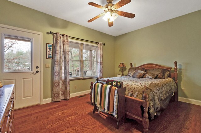 bedroom featuring dark wood-type flooring, multiple windows, visible vents, and baseboards