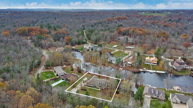 bird's eye view with a water view, a wooded view, and a residential view