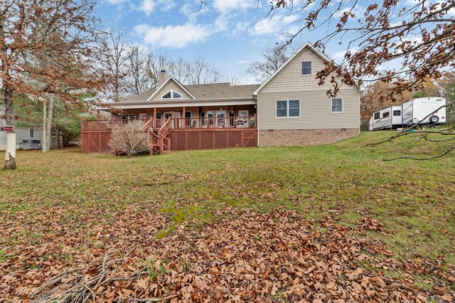 back of property with crawl space, a yard, and a chimney