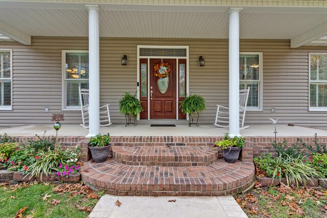 view of exterior entry featuring a porch