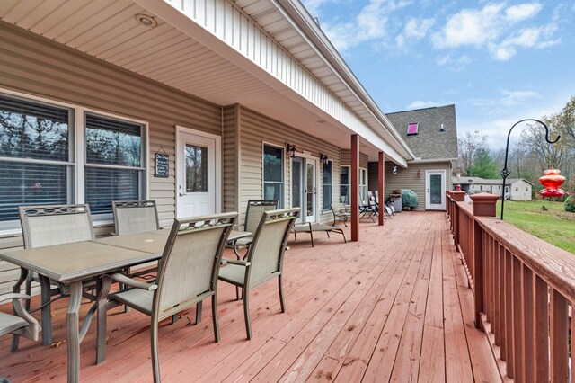 wooden terrace with outdoor dining space