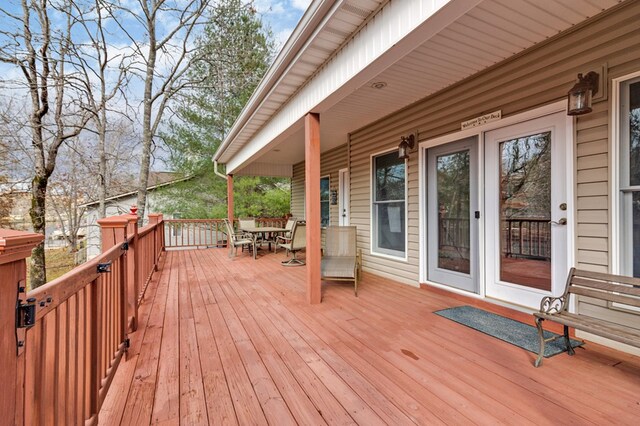 wooden terrace featuring outdoor dining area