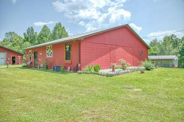 5088 Baptist Ridge Rd, Hilham, TN 38568 - view of side of property featuring concrete block siding, a lawn, and an outdoor structure