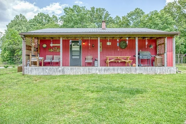 5088 Baptist Ridge Rd, Hilham, TN 38568 - view of front of home featuring a chimney, a front lawn, a porch, and a metal roof