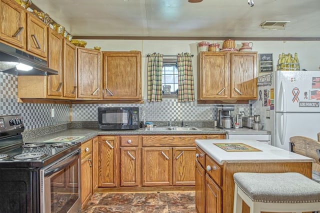 5088 Baptist Ridge Rd, Hilham, TN 38568 - kitchen with electric stove, black microwave, under cabinet range hood, freestanding refrigerator, and decorative backsplash
