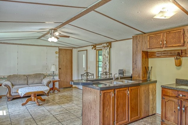 5088 Baptist Ridge Rd, Hilham, TN 38568 - kitchen with a ceiling fan, brown cabinetry, dark countertops, a peninsula, and vaulted ceiling