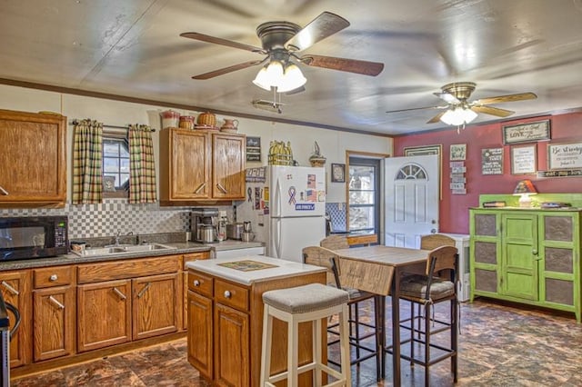 5088 Baptist Ridge Rd, Hilham, TN 38568 - kitchen featuring black microwave, freestanding refrigerator, brown cabinetry, ceiling fan, and crown molding