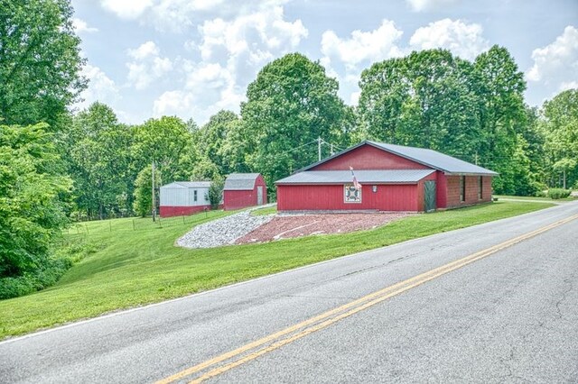 5088 Baptist Ridge Rd, Hilham, TN 38568 - view of property exterior featuring a lawn and an outbuilding