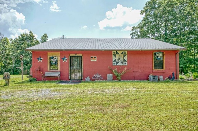 5088 Baptist Ridge Rd, Hilham, TN 38568 - view of front of house featuring concrete block siding, a front lawn, and a metal roof