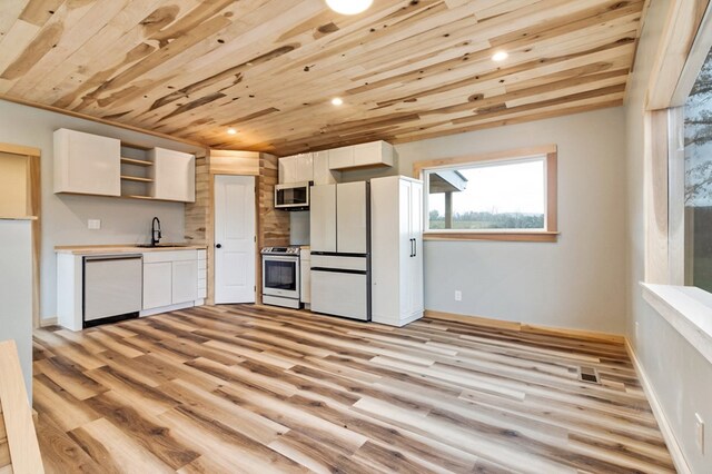 kitchen with dishwashing machine, stainless steel stove, a sink, light countertops, and open shelves