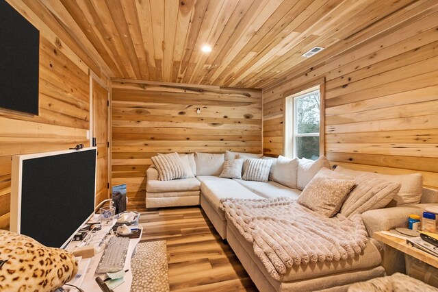 living room featuring wooden ceiling, wood walls, and wood finished floors