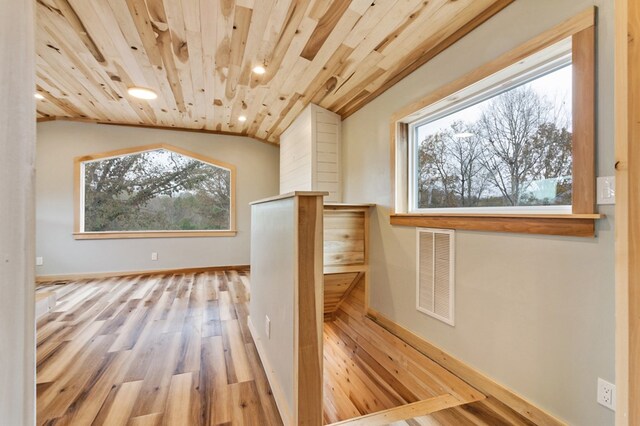 bonus room featuring lofted ceiling, wooden ceiling, visible vents, and wood finished floors