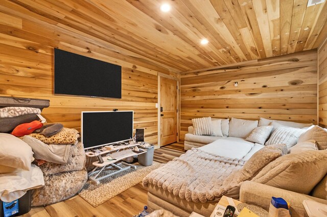 living room featuring wooden ceiling, wooden walls, and wood finished floors