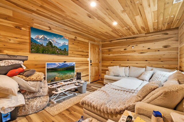 living area featuring wooden ceiling, wood finished floors, and wooden walls