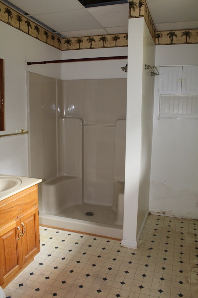 full bath with a shower, vanity, and tile patterned floors