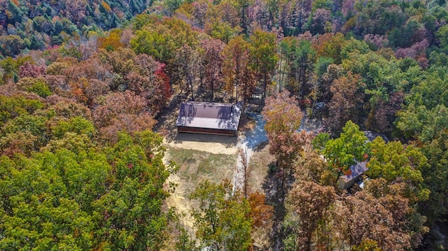 birds eye view of property with a wooded view