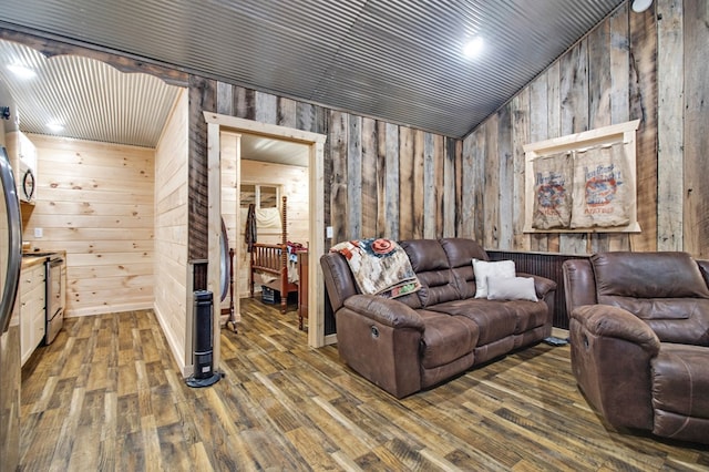 living area with dark wood-style flooring and wooden walls