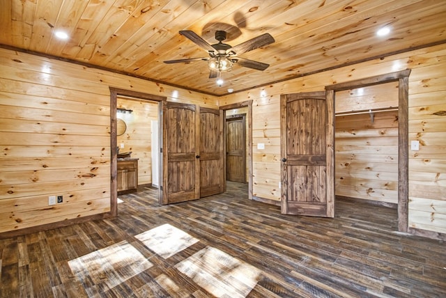 unfurnished bedroom featuring ensuite bath, wood walls, wood ceiling, and dark wood-style flooring