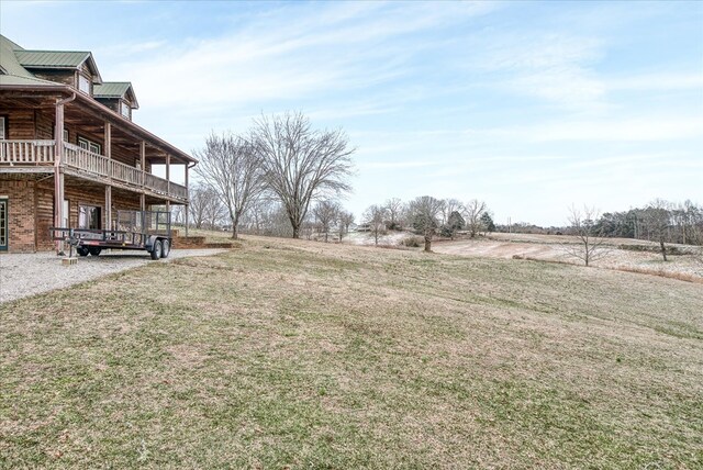 view of yard featuring a rural view and a balcony